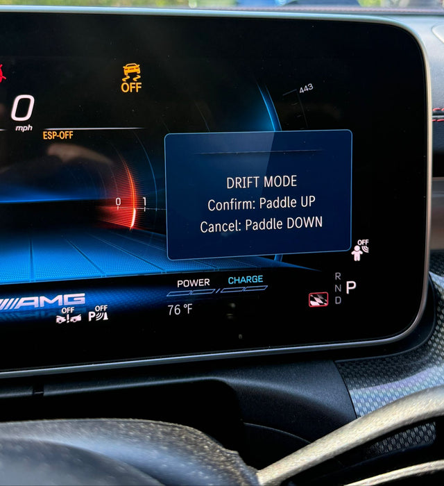 Car dashboard display with drift mode menu on a blurred background