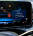 Car dashboard display with drift mode menu on a blurred background